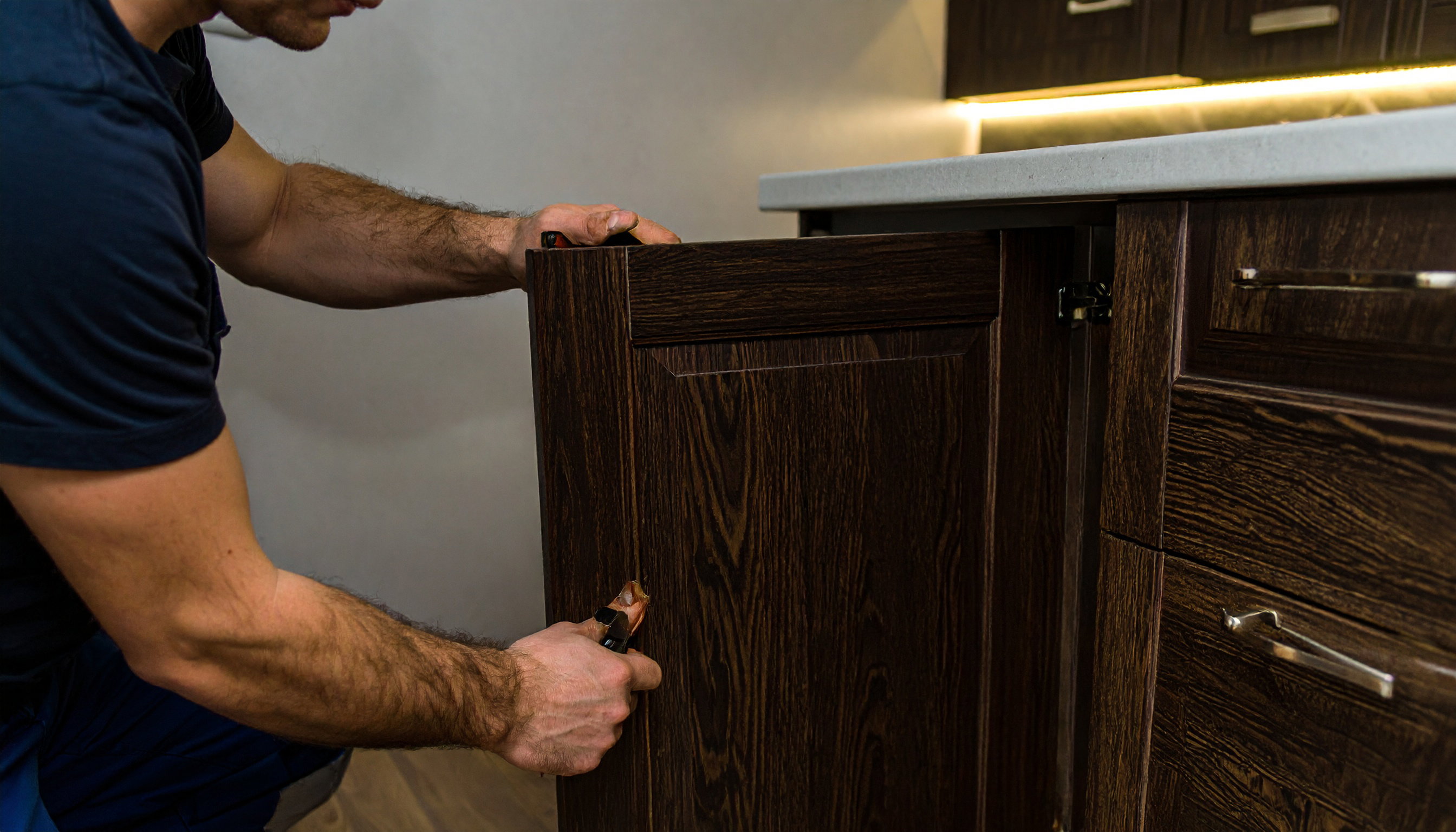 Firefly-professional-carpenter-installing-kitchen-cabinet-75838.jpg